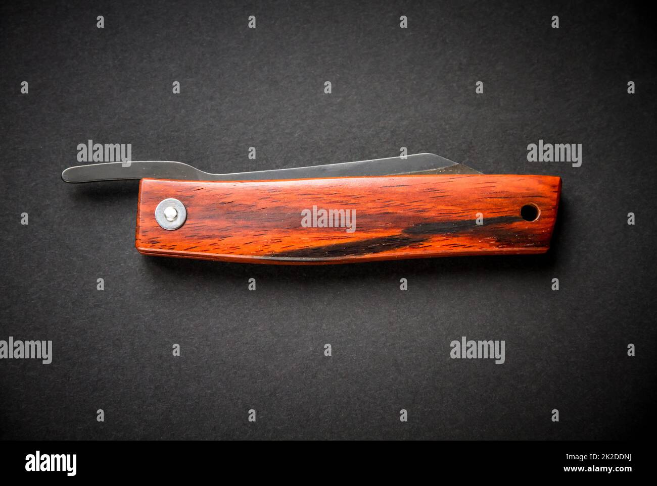 Traditional wooden japanese pocket knife on black background Stock