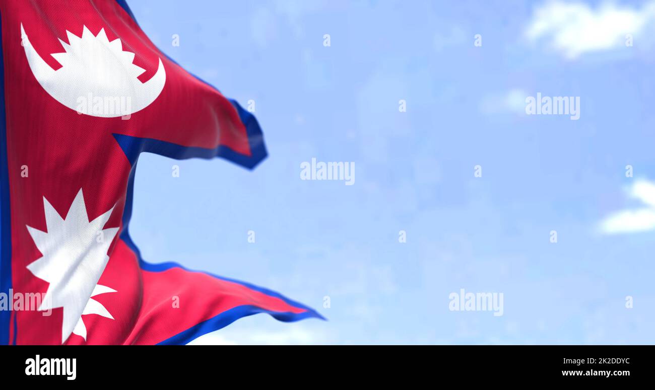 Detail of the national flag of Nepal waving in the wind on a clear day Stock Photo