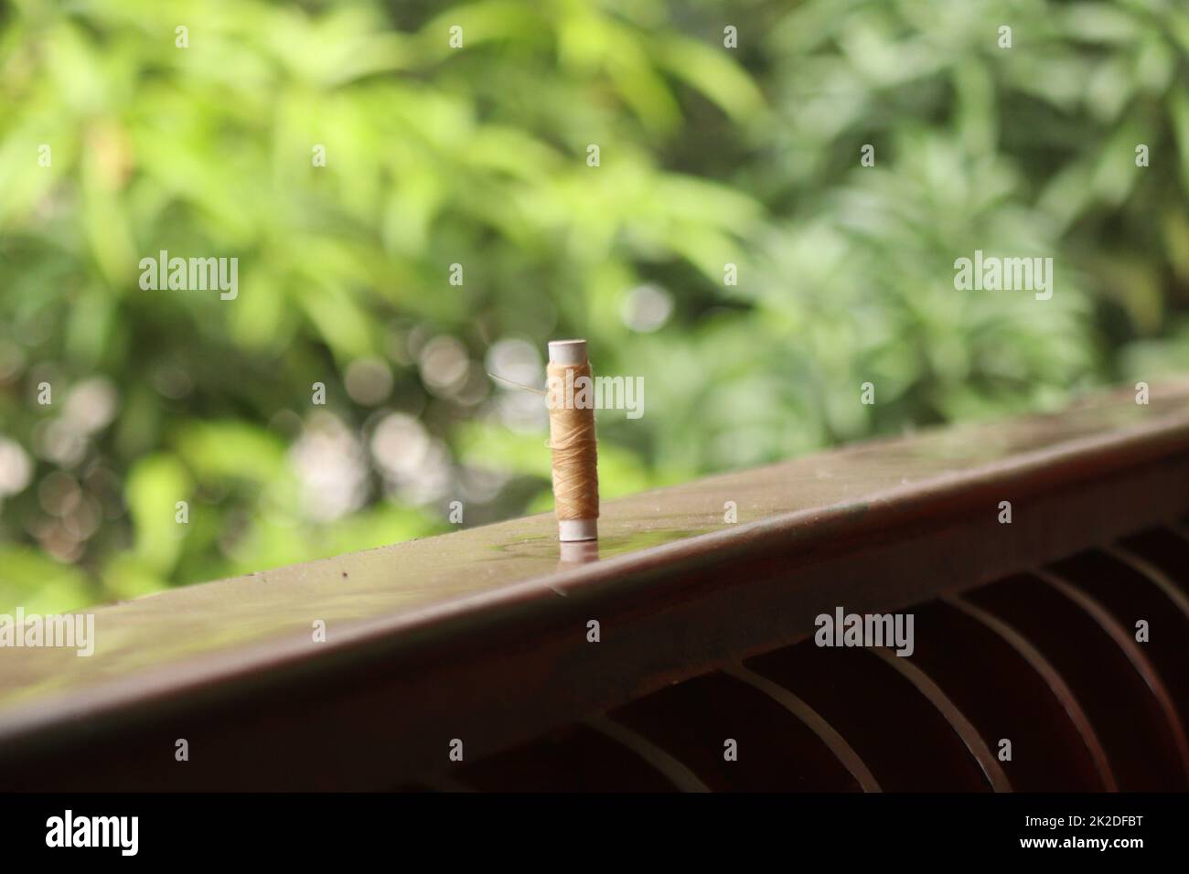 A sewing thread placed on a dusty floor Stock Photo - Alamy