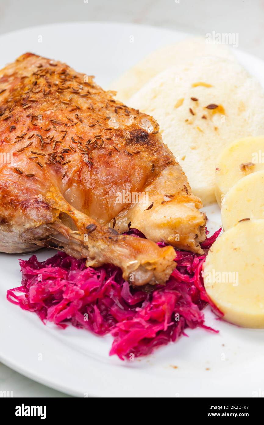 roasted goose leg with red cabbage and dumplings Stock Photo Alamy