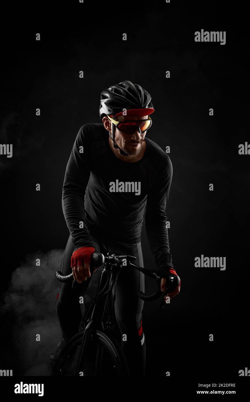 male cyclist with road bicycle on black background Stock Photo