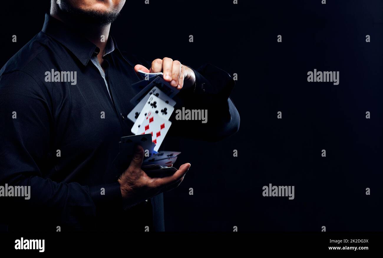 Magician illusionist showing performing card trick Stock Photo Alamy