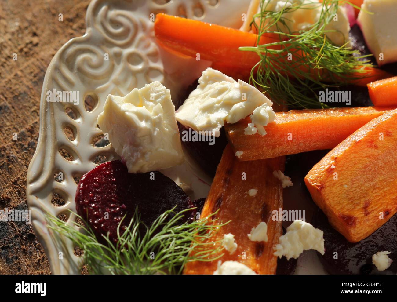 Healthy grilled beet, carrots salad with cheese feta, fennel , top view