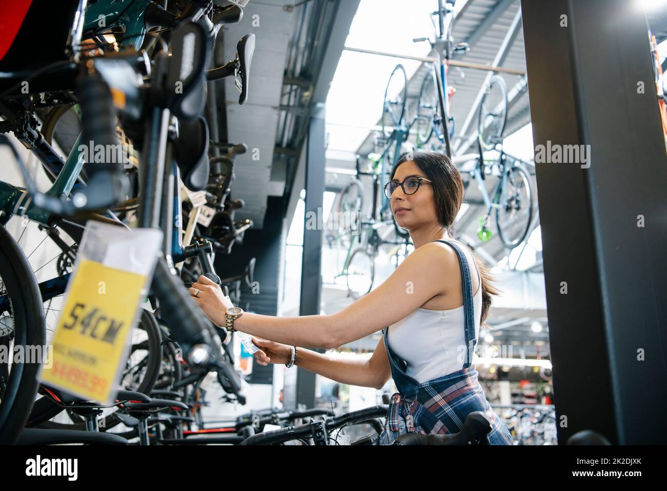 Female bike shop owner checking inventory Stock Photo Alamy