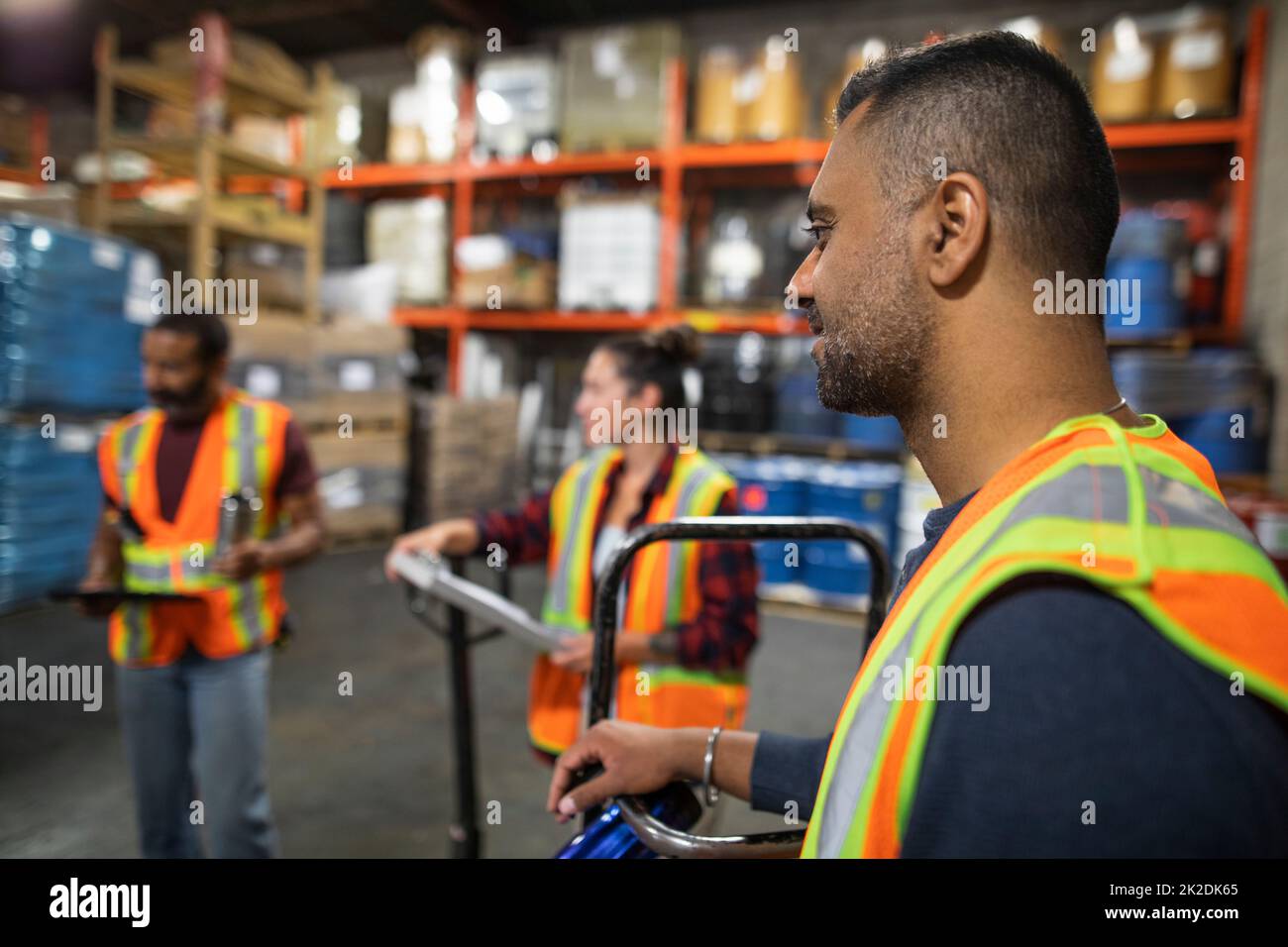 Distribution warehouse owner and workers having team meeting Stock