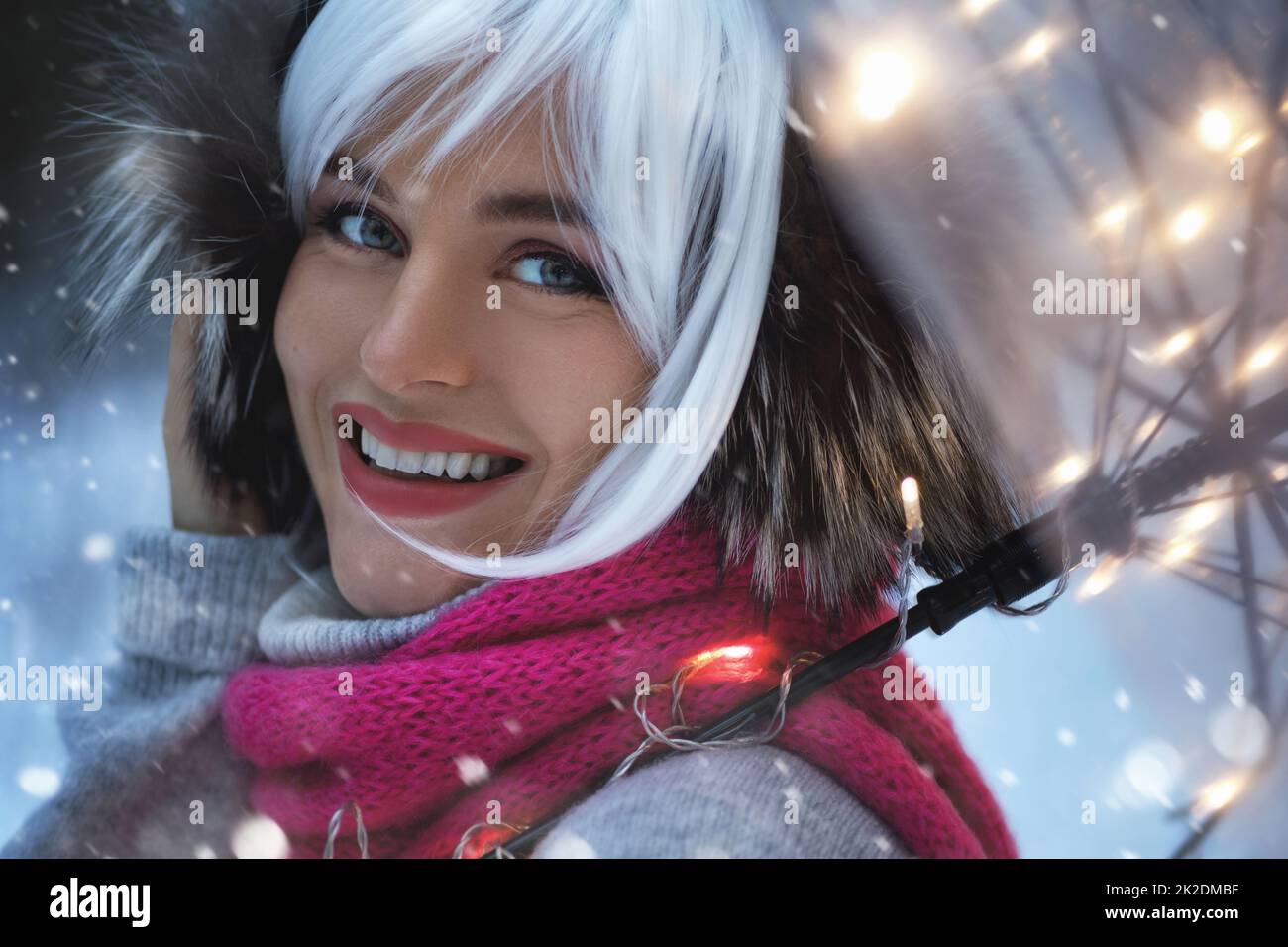 Young woman walking under transparent umbrella at snowy winter day Stock Photo