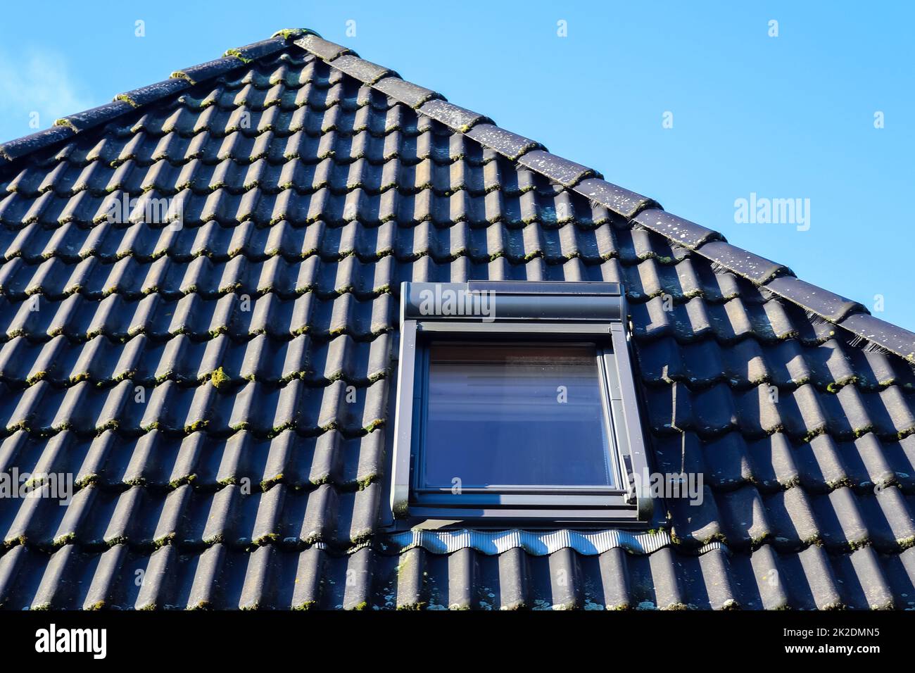 Open roof window in velux style with black roof tiles Stock Photo Alamy