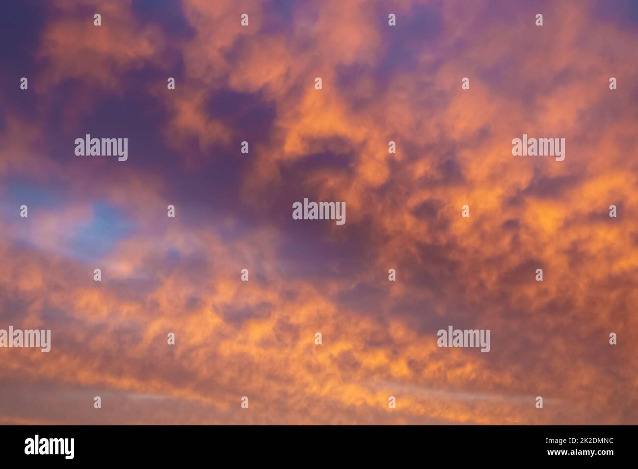 Beautiful panorama of orange and yellow clouds at sunrise Stock Photo