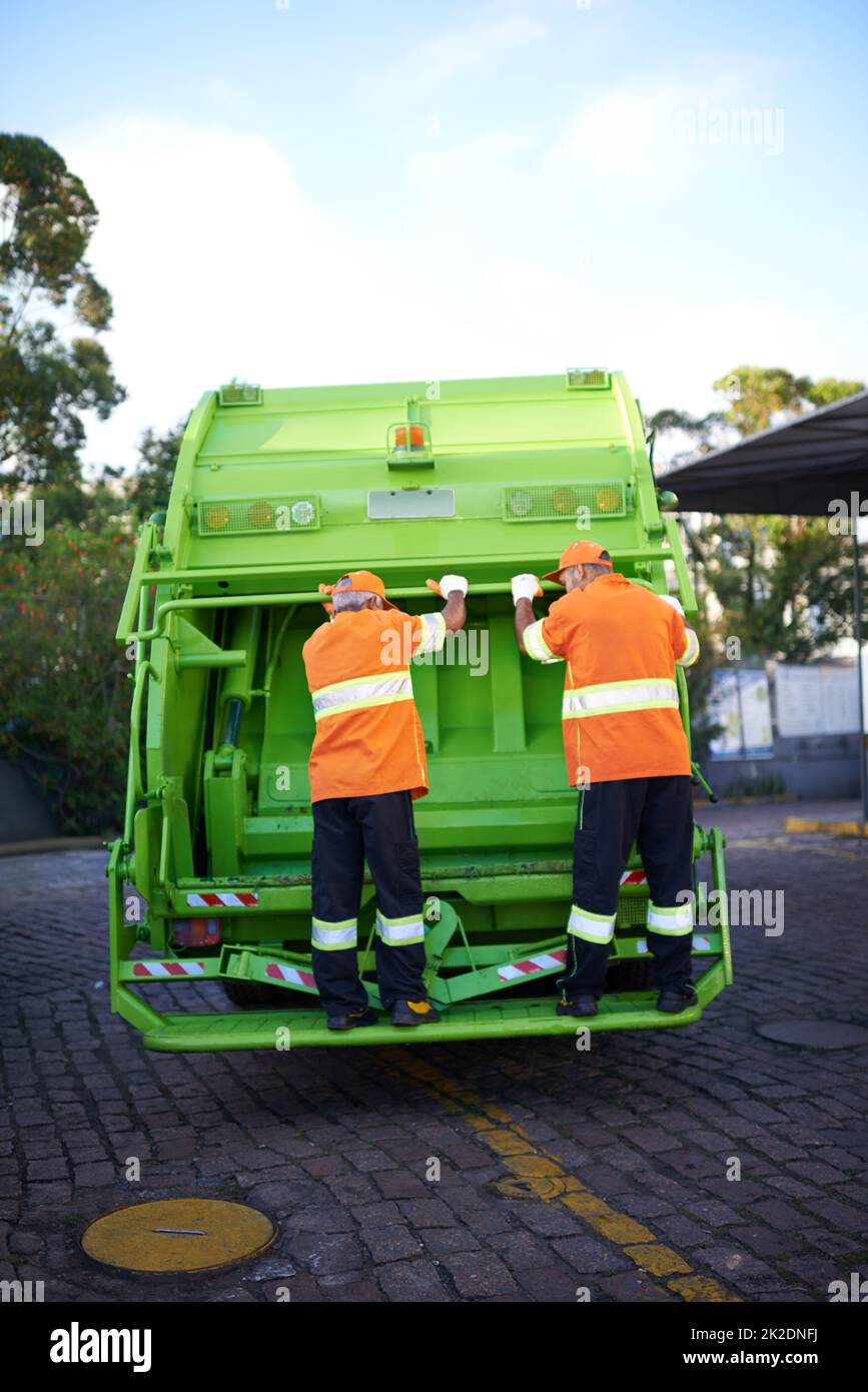 Garbage collection day. Cropped shot of a garbage collection team at