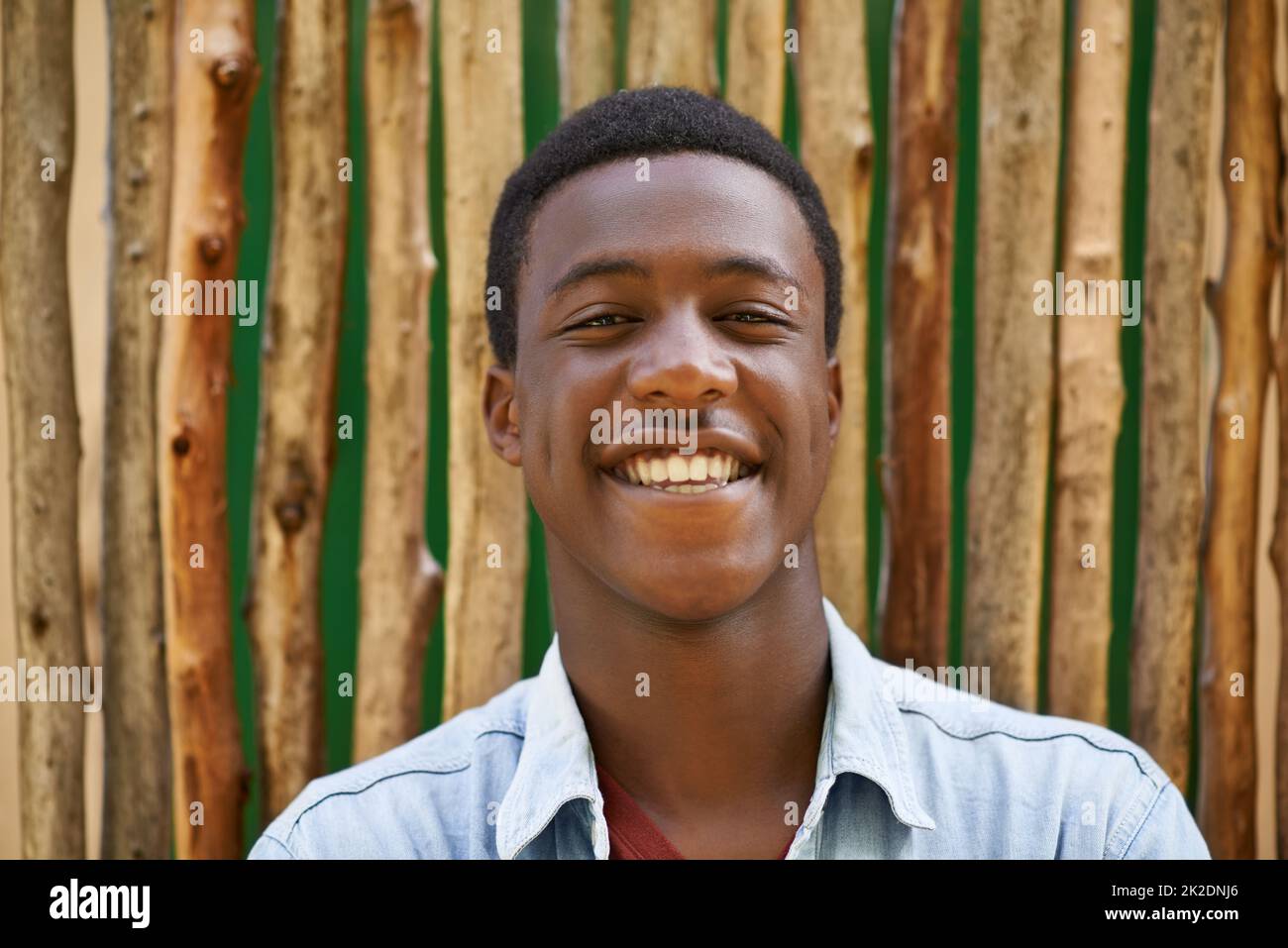 Hes one of the popular guys. Shot of a handsome teenage boy standing in the outdoors. Stock Photo