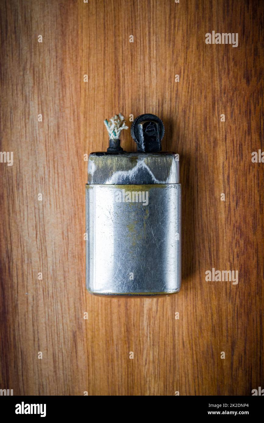 Old vintage lighter on a wooden background Stock Photo
