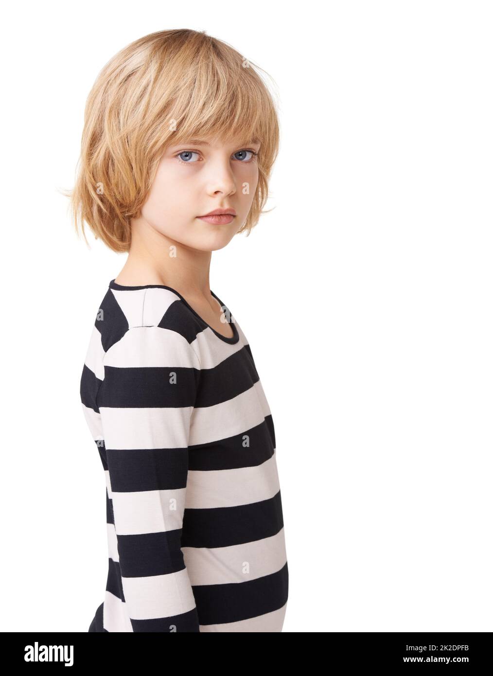 Striped sweetheart. Portrait of a pretty little girl standing profile against a white background. Stock Photo