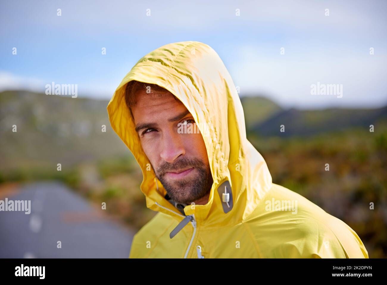 Rain or shine, I run. Portrait of a handsome man in running rain gear