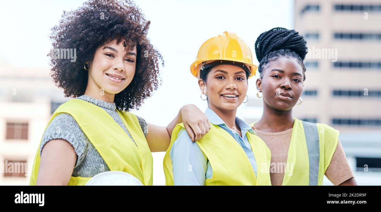 Were giving this city a makeover. Portrait of a group of confident young businesswomen working at a construction site. Stock Photo