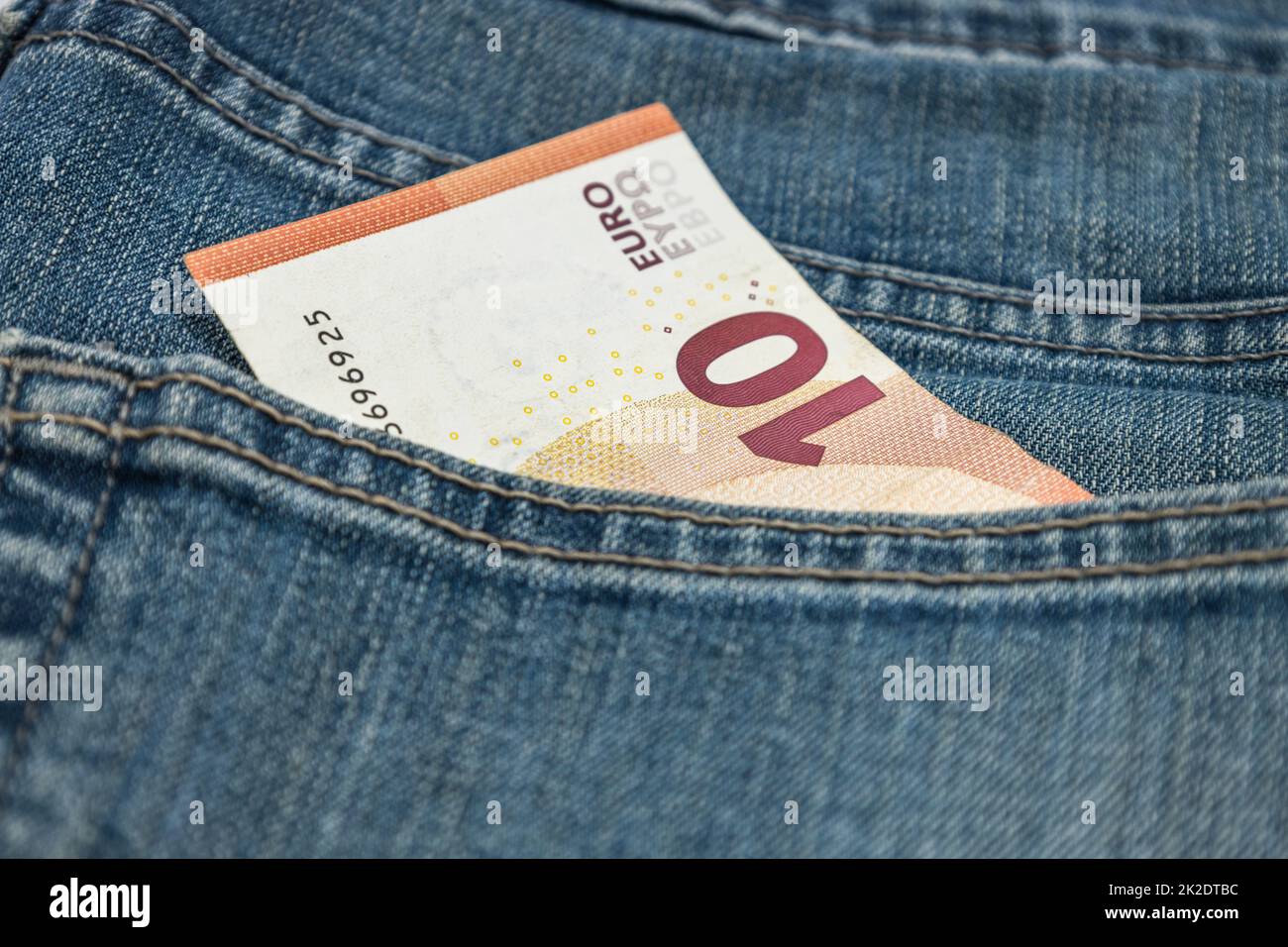 Money in the pocket. Ten euro note in the pocket of blue jeans Stock