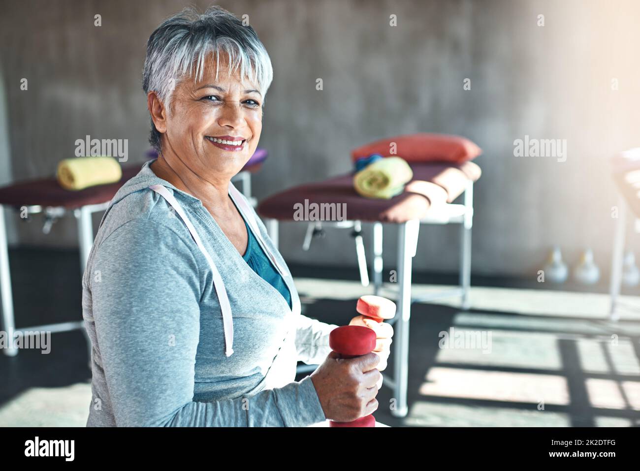 Forever fit, thats my motto. Portrait of a happy senior woman working out with weights. Stock Photo