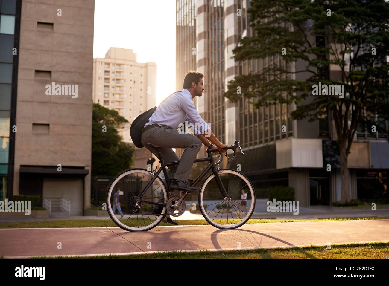 Commuting the carbon-free way. Shot of a businessman commuting to work with his bicycle. Stock Photo