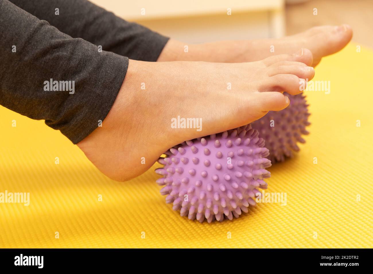 Female feet and purple prickly massage balls Stock Photo Alamy