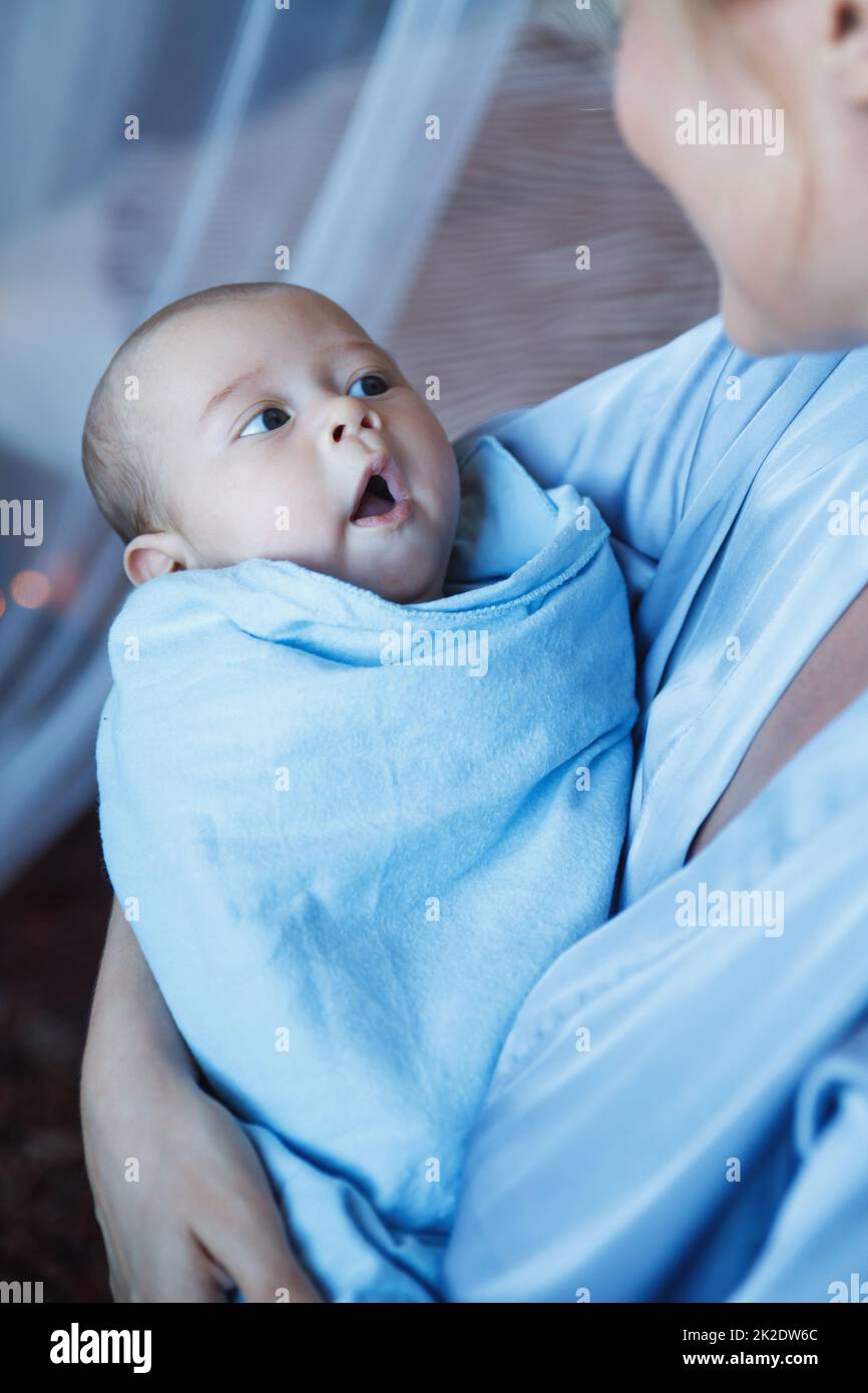 Sleepy infant baby in his mother's hands Stock Photo