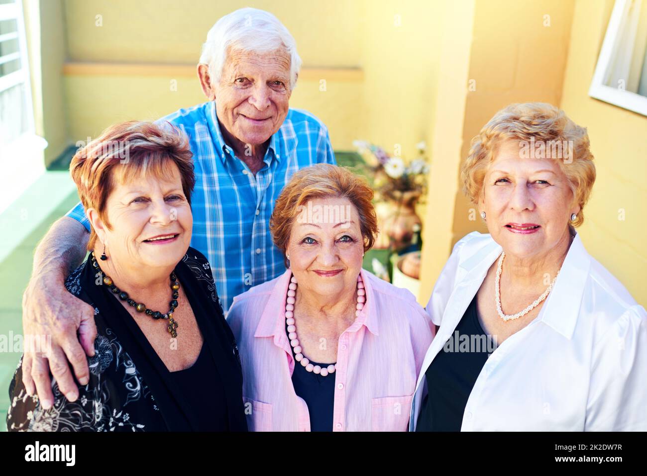 Back to being ourselves. Shot of a group cheerful elderly people smiling and posing for the camera outside of a building. Stock Photo