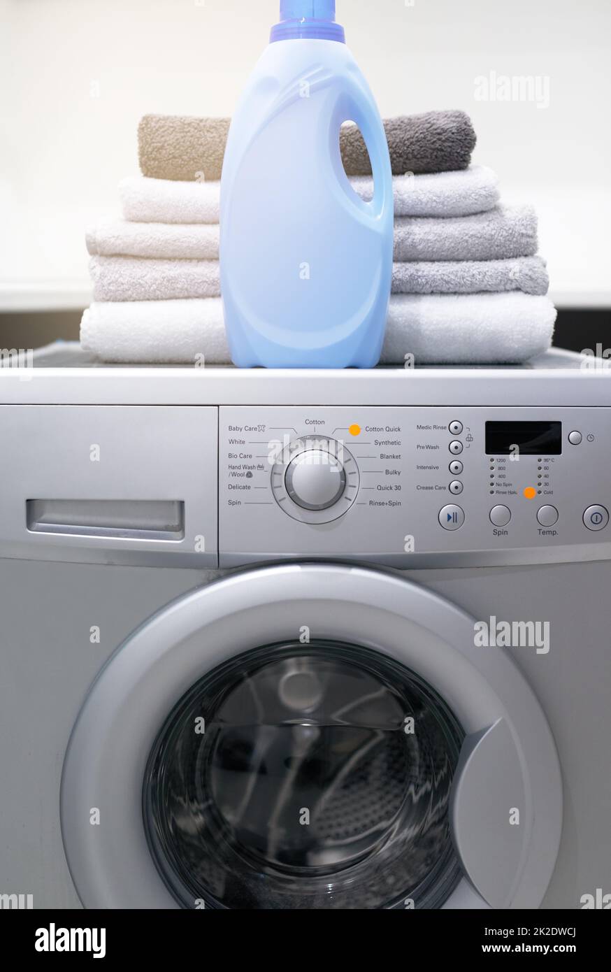 Your laundry will love it. Shot of a washing machine with folded towels