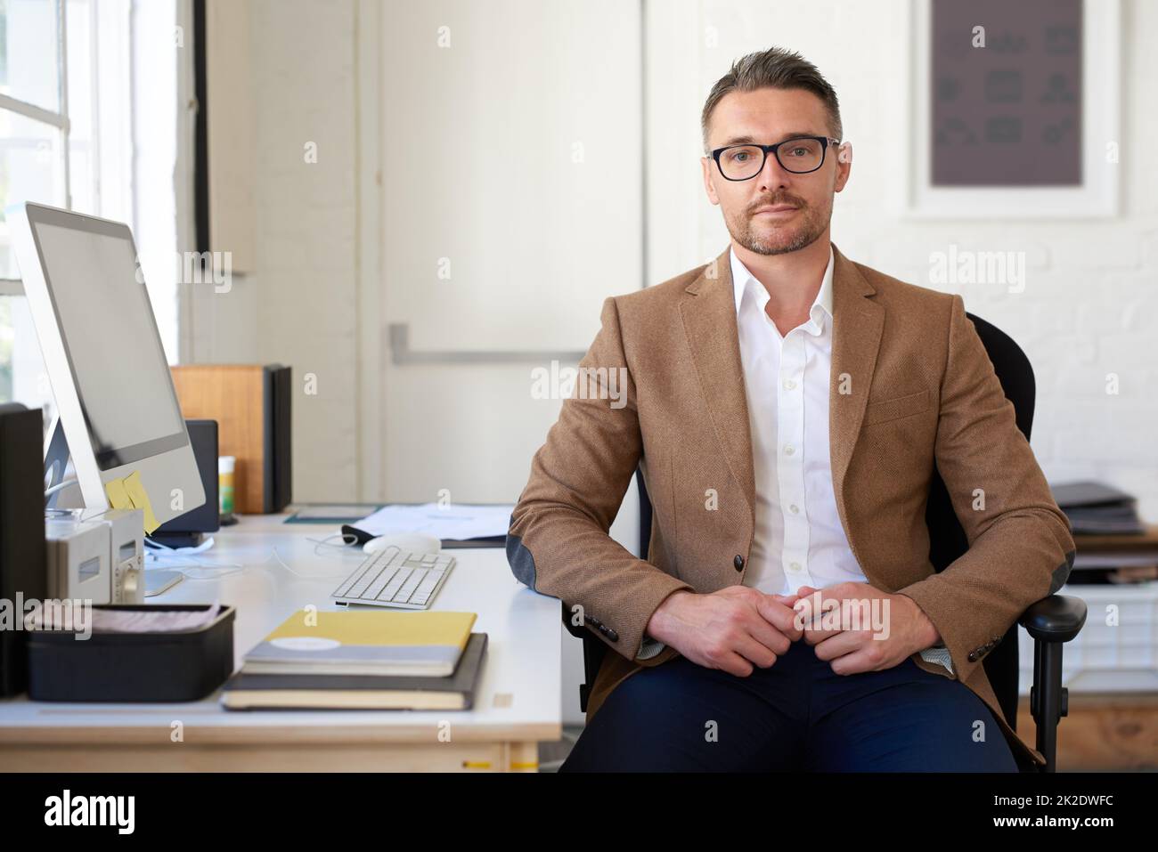 When you need innovation you trust. Portrait of a positive mature creative professional at his desk. Stock Photo