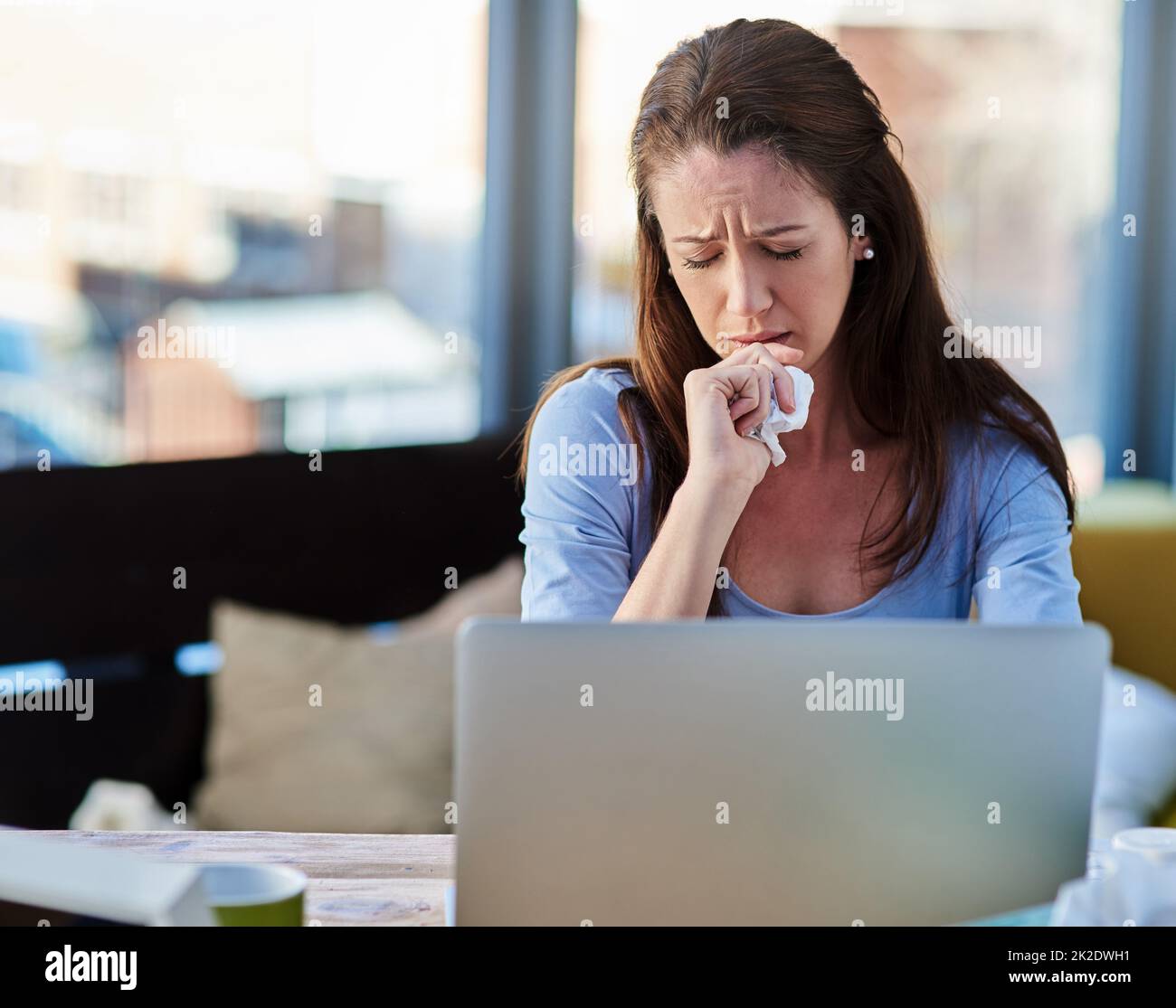 Sick with a stuffy nose. Cropped shot of a young woman feeling unwell at home. Stock Photo