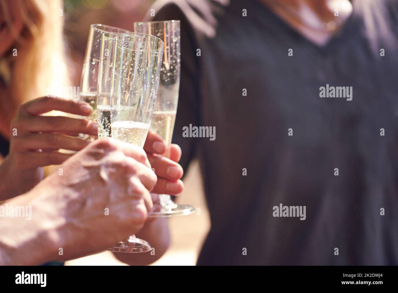 Liquid sparkle. Cropped shot of people drinking champagne together in an outdoor setting. Stock Photo