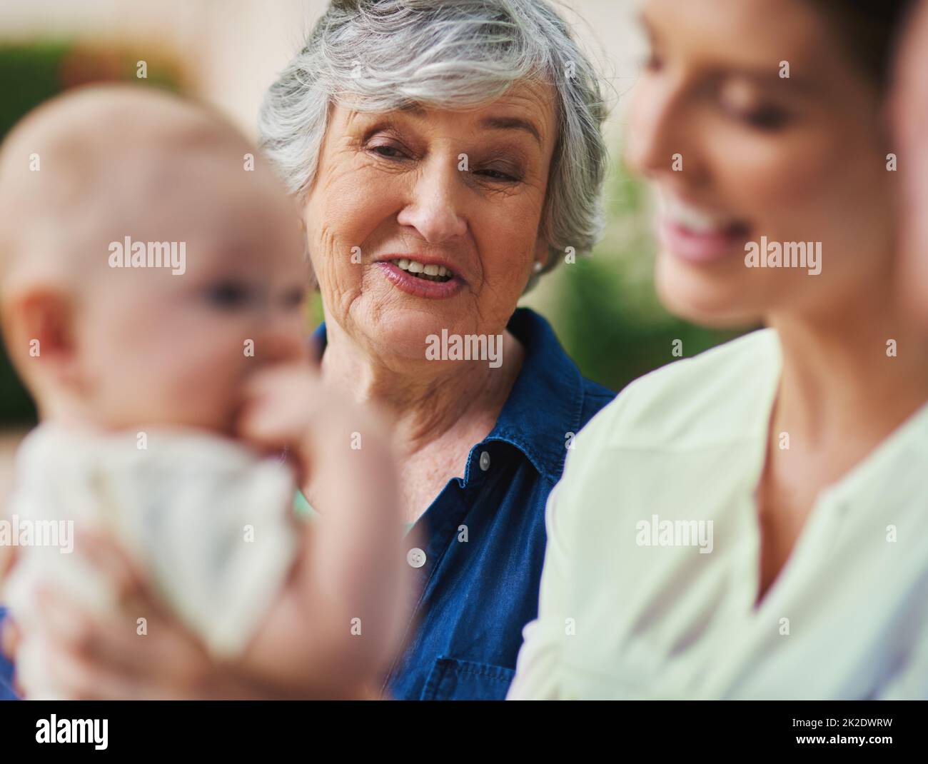 Hes just so adorable. Cropped shot of a three generational family spending time outdoors. Stock Photo