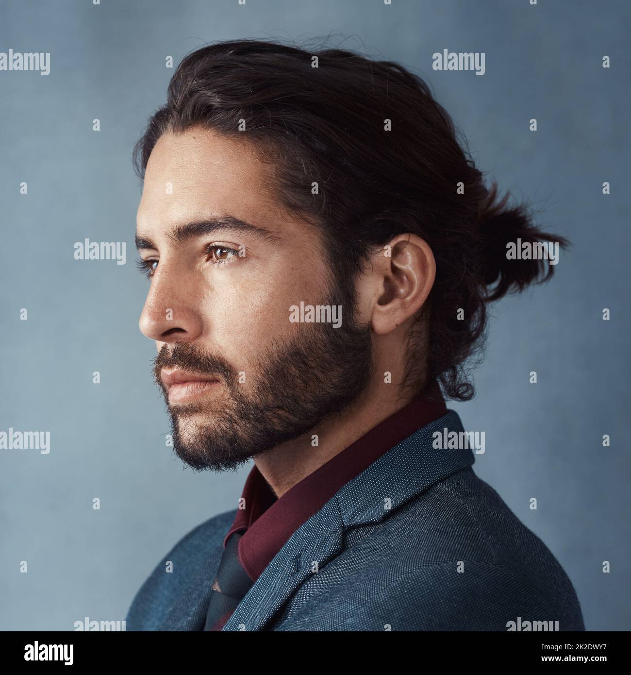 Have a vision and make it happen. Studio shot of a handsome young man looking thoughtful against a grey background. Stock Photo