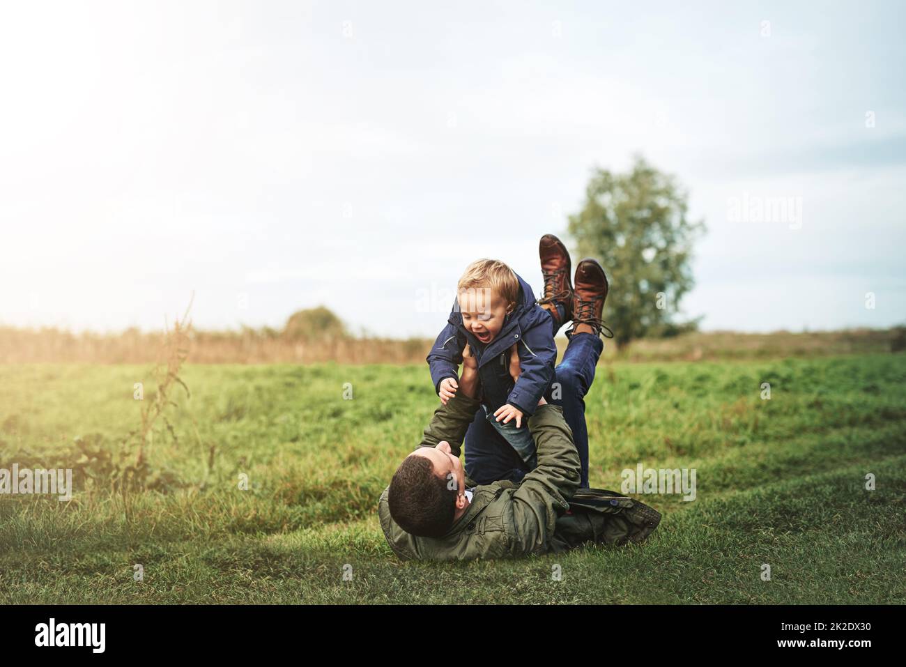 Being together is the best feeling ever. Shot of a father bonding with his son outside. Stock Photo