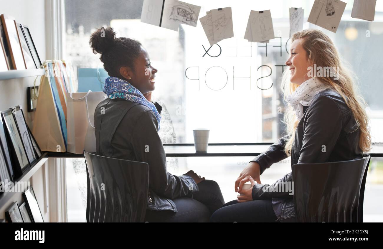 Enjoying a cup of coffee together. Two young women buying coffee
