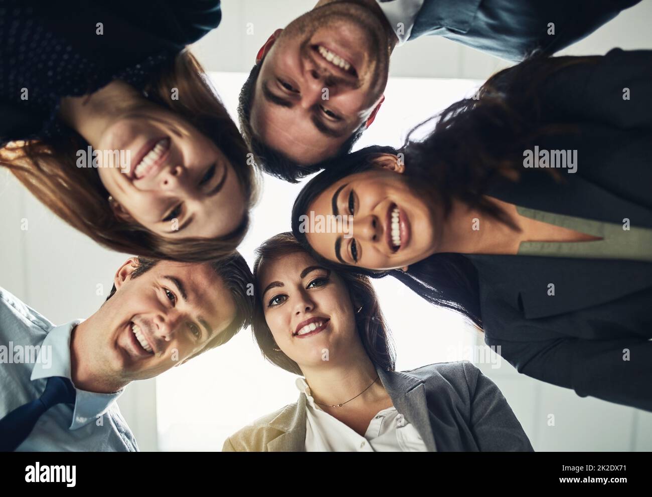 The best collaborate with the best. Low angle shot of a group of young businesspeople huddled together in solidarity. Stock Photo