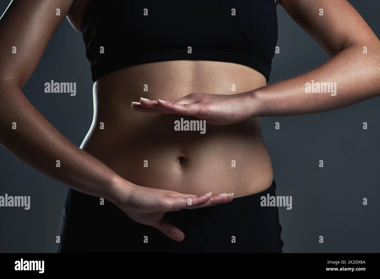 Keeping it healthy and balanced. Closeup shot of a sporty womans midsection. Stock Photo