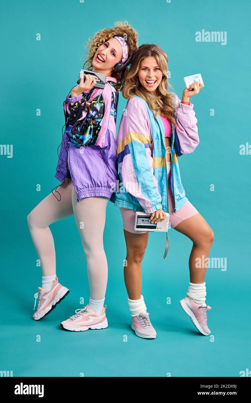 Were out spreading some 80s vibes. Studio shot of two beautiful young women  styled in 80s clothing Stock Photo - Alamy