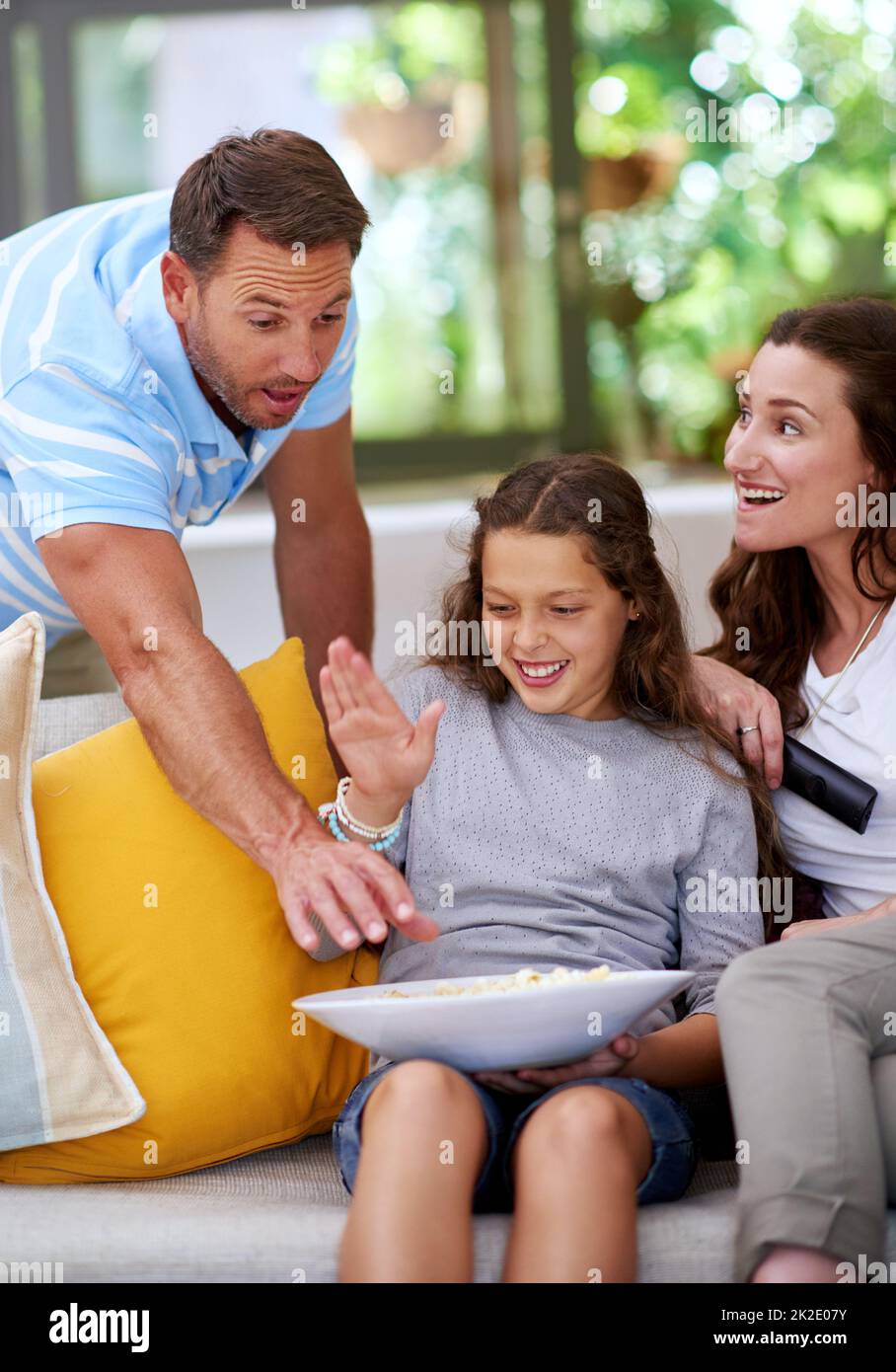 Gimme that popcorn. Cropped shot of a father teasing his daughter while watching a movie. Stock Photo