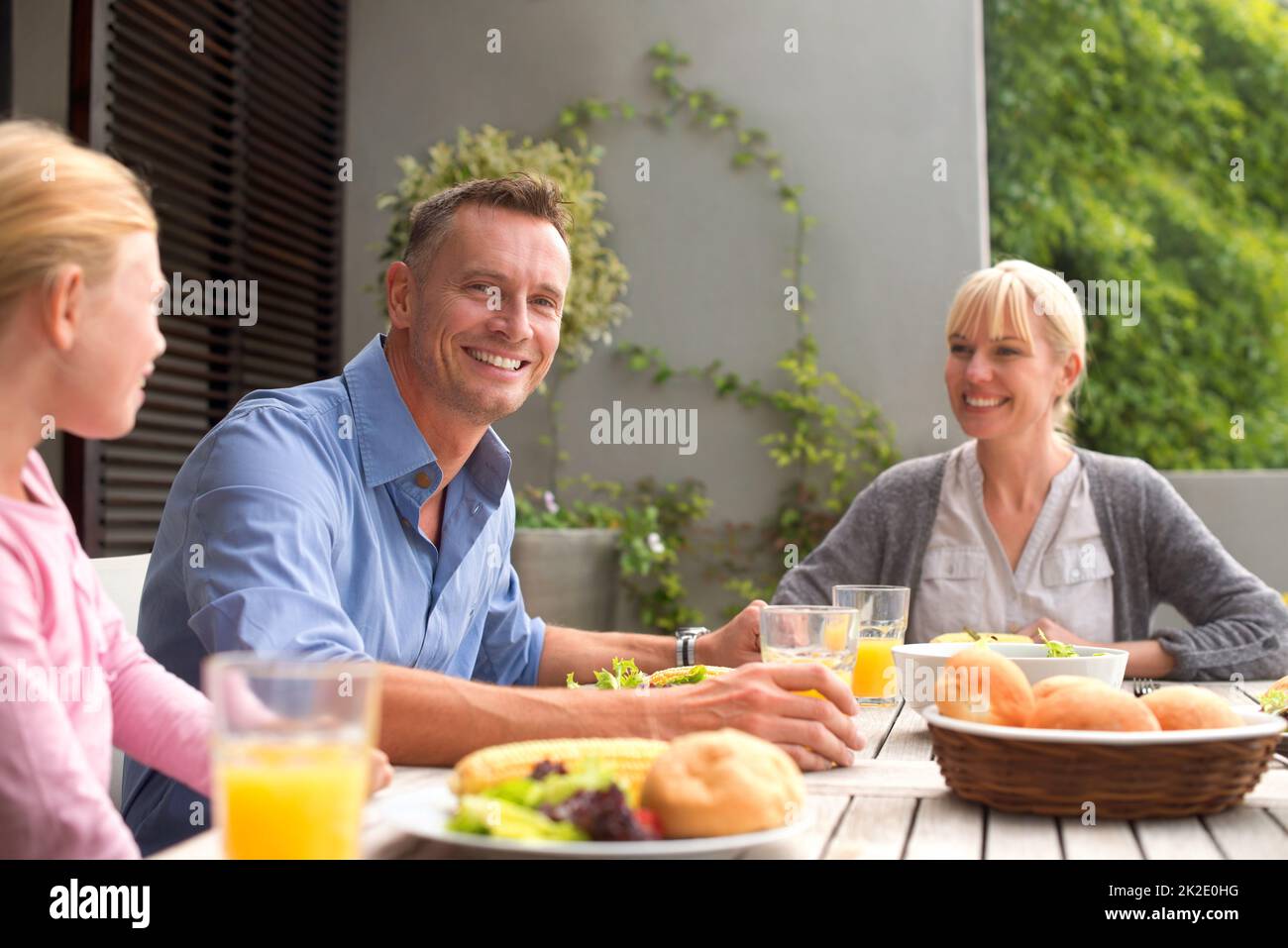 Enjoying lunch as a family. A cropped shot of a happy family enjoying a meal together outdoors on a sunny day. Stock Photo