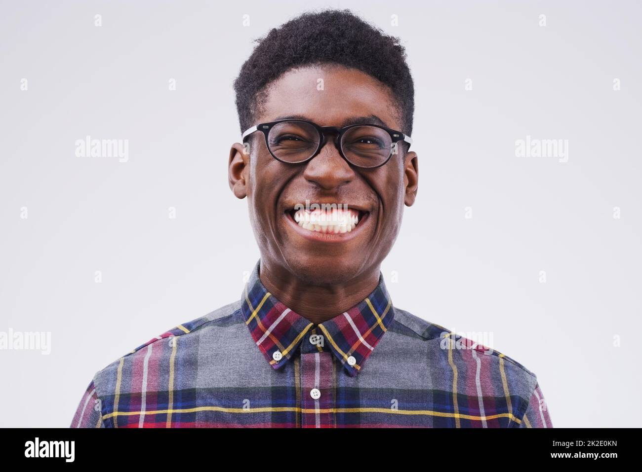 Lifes better when youre smiling. Studio shot of a young man making a funny face against a gray background. Stock Photo
