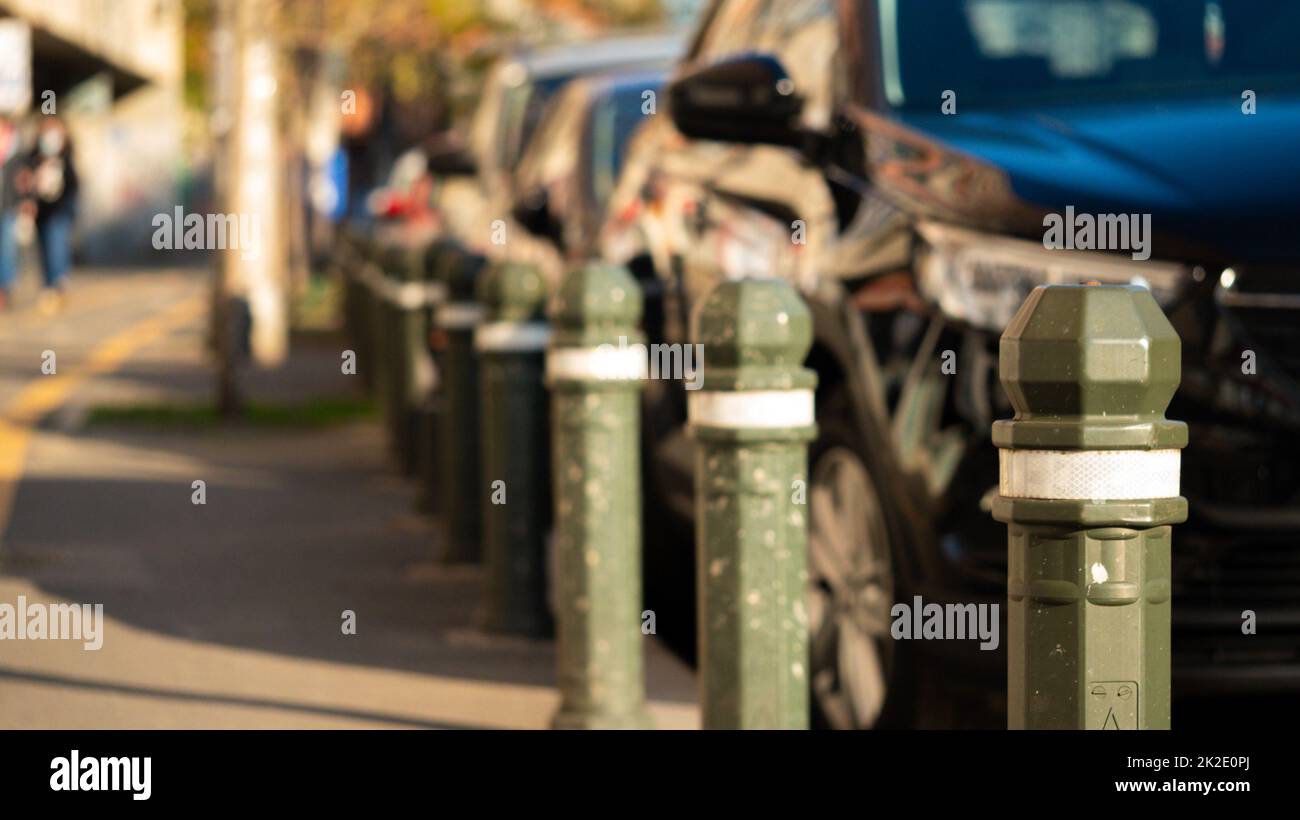 Row of plastic pillars between road street and pedestrian sidewalks. Stock Photo