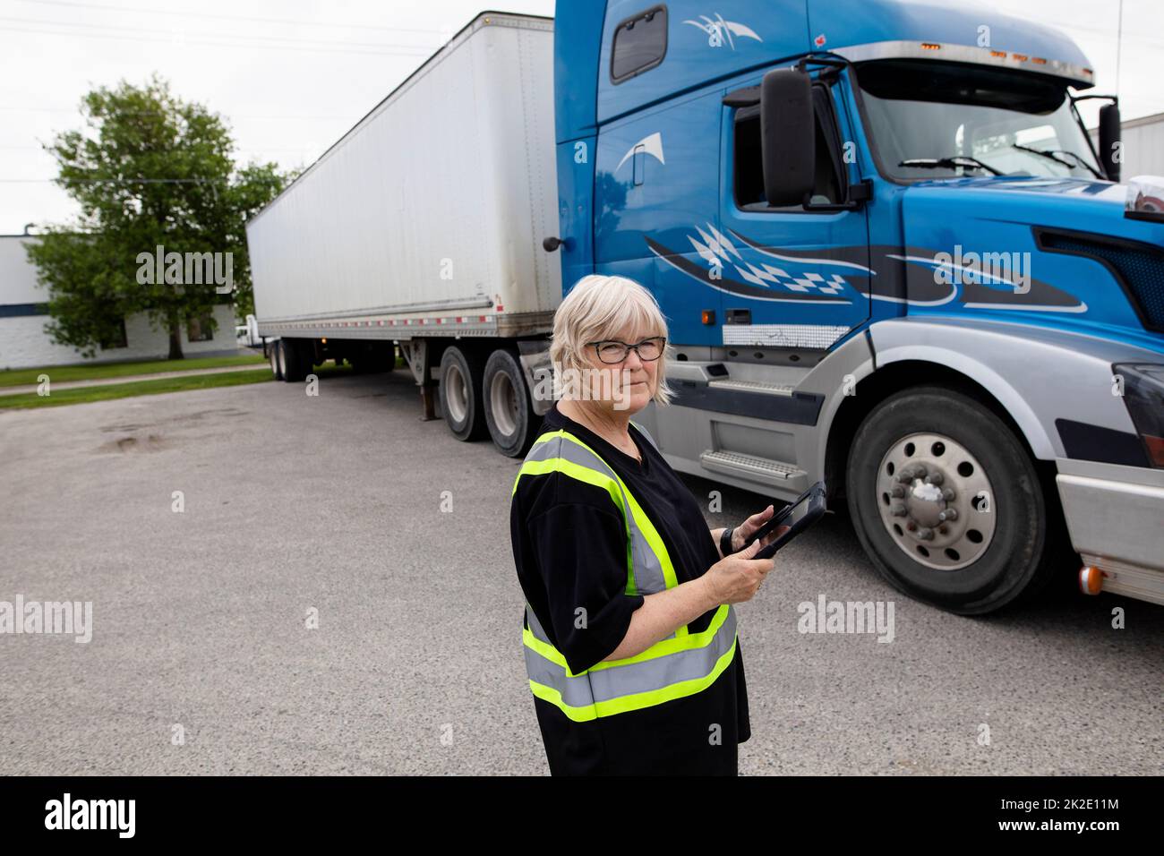 Warehouse owner with tablet beside container semi truck Stock Photo Alamy
