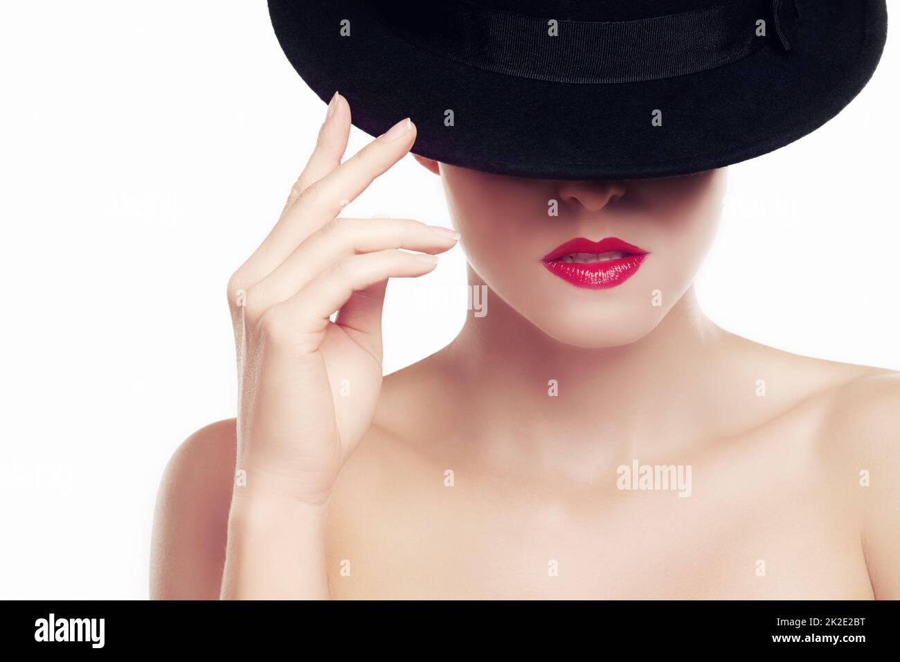 Bold style. Beauty shot of a young woman wearing a hat and red lipstick. Stock Photo