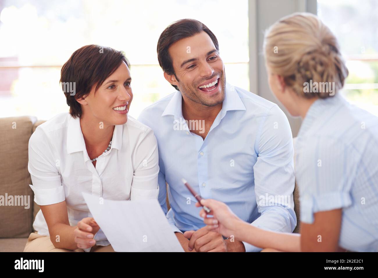 Making smart investment choices. Shot of a financial advisor explaining documents to a couple. Stock Photo