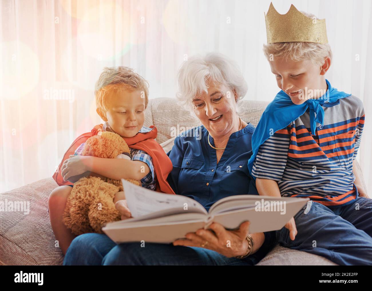 Keeping them entertained. Shot of a senior woman spending time wither her grandsons. Stock Photo