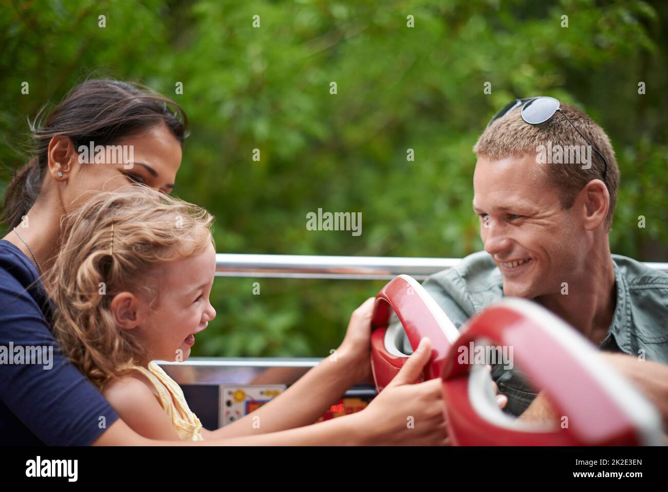 Are you ready to see Disneyland. Shot of a happy young family sitting on a bus. Stock Photo