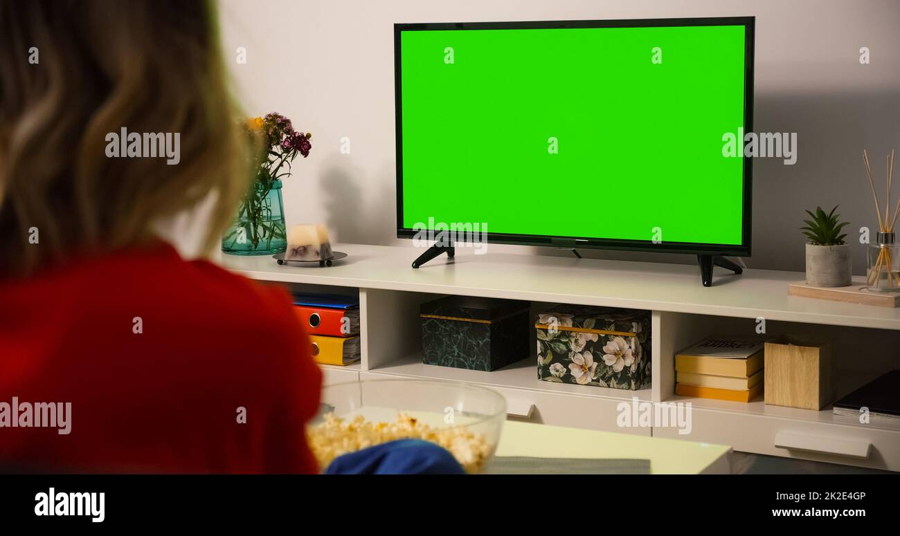 Green Screen TV Close up. Shot behind model Shoulder watching Tv