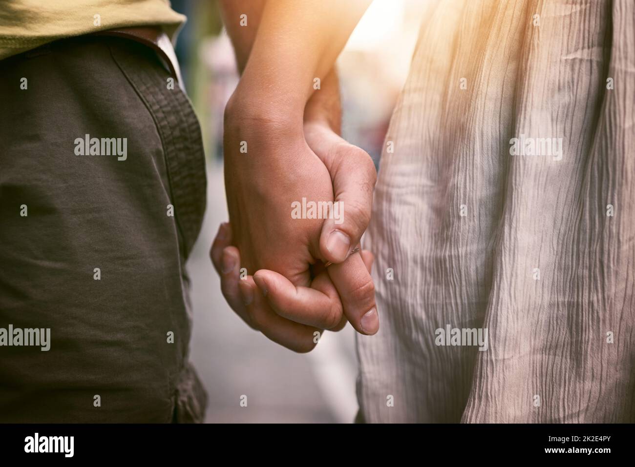 My hand will always have room for your hand. Cropped shot of an affectionate couple holding hands outdoors. Stock Photo