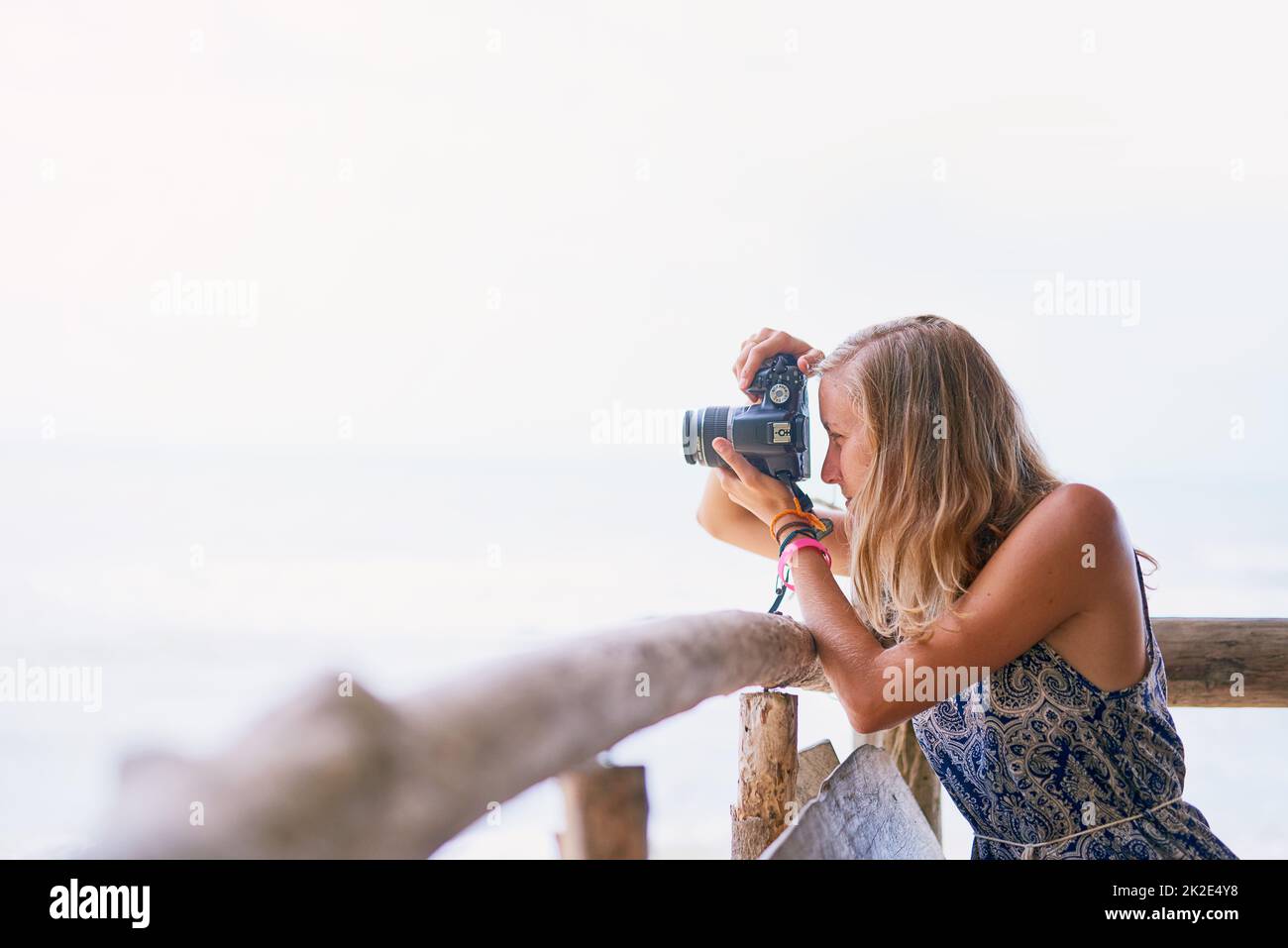 Framing the perfect holiday photo. Shot of a young woman taking pictures while on holiday in Thailand. Stock Photo