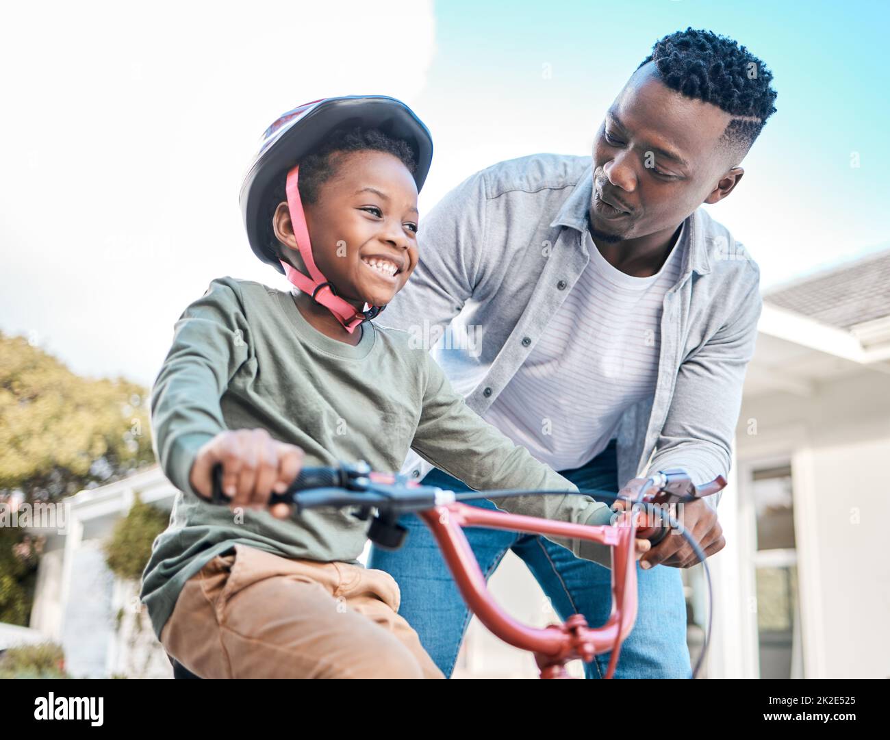 Father teaching little son riding bicycle hi res stock photography