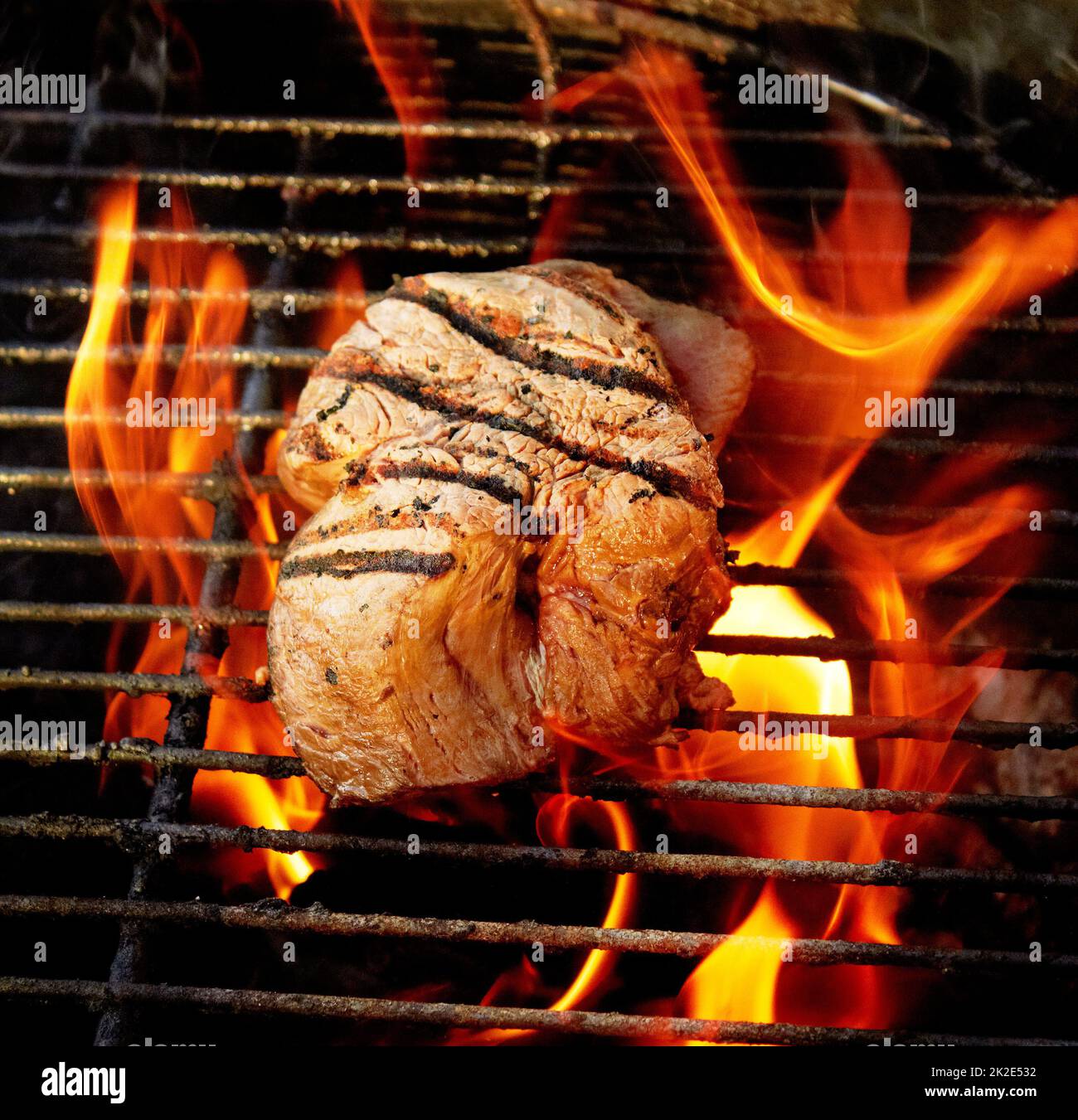 Juicy and tender. Closeup of a tasty steak cooking on a fire Stock