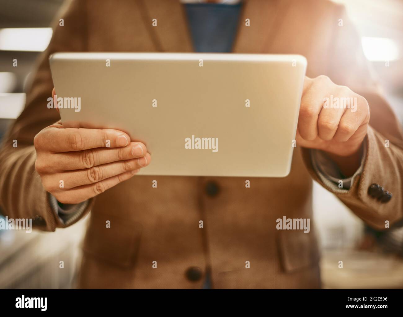 Digital design. Low angle shot of an unrecognizable male designer working on a tablet in his office. Stock Photo